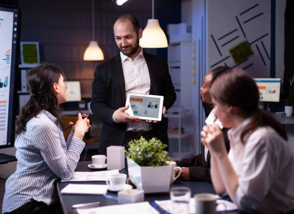 entrepreneur-businessman-showing-company-strategy-using-tablet-corporate-presentation-min-scaled
