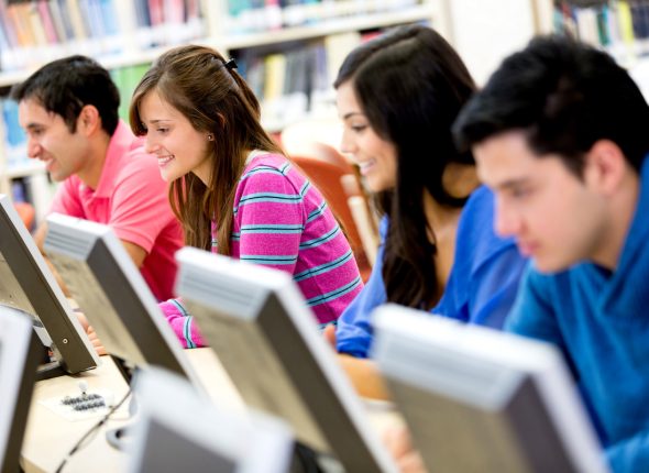 Group,Of,Young,People,Studying,At,The,Library,Using,Computers
